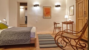 A bedroom with a bed, a desk, a chair, and a wardrobe. - LA RONDINAIA. CHARMING HOUSE WITH GARDEN AND POOL. AMAZING VIEW (CASTELNUOVO BERARDENGA)