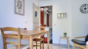 A dining area with a wooden table and chairs, a small potted plant, and a clock on the wall. - #CP - House - Magnificent view - garden 💓 (Lumbin)