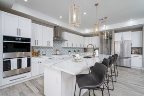 Fridge, microwave, oven, stovetop - 607 Bliss on the Bay: 5BR Oasis w/ Pool, Spa & Views (Fort Myers Beach)