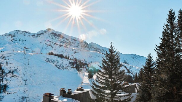 A snow-covered mountain village with traditional buildings, a ski lift, and a clear sky. - Immodreams - Le Vivace - Avoriaz (Avoriaz)