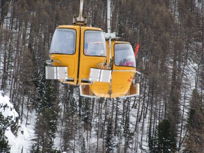 A yellow cable car suspended by cables, surrounded by a snowy forest. - Balcony & serenity: peak views (Briançon)
