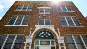 A multi-story building with a prominent sign reading "Ambassador Hotel".