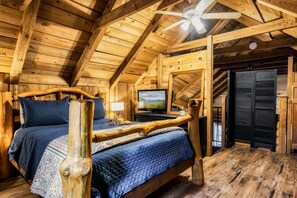 Relax in this charming bedroom with a large bed, wooden headboard, and a cozy reading nook.