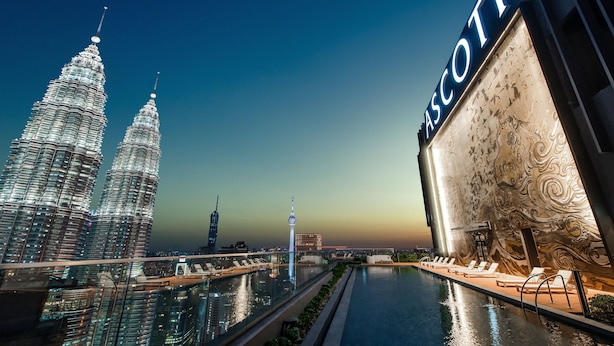 A modern hotel with a large pool, two prominent towers in the background, and a distinctive building with a wave-like facade. - Ascott Star KLCC Kuala Lumpur (Kuala Lumpur)