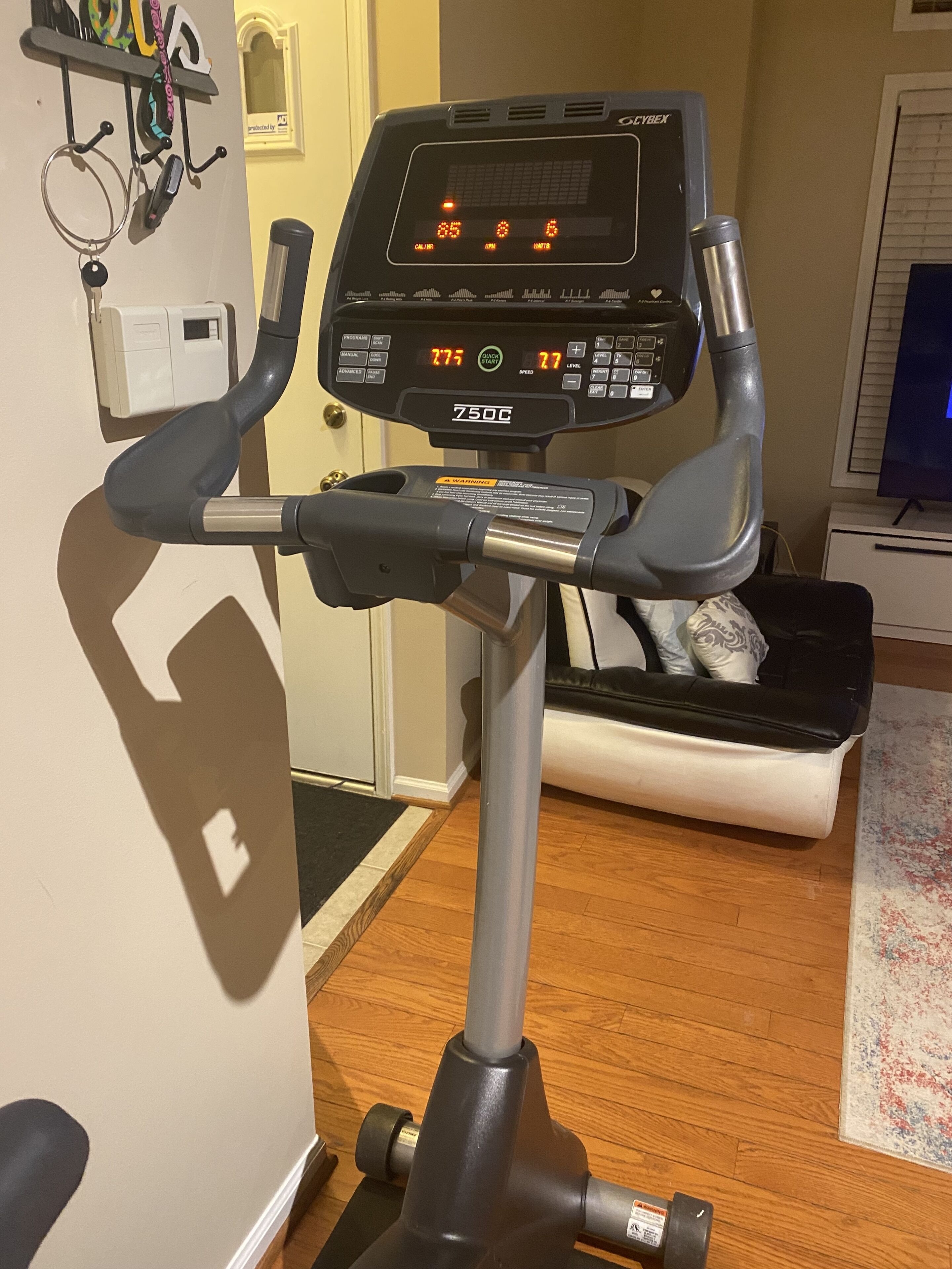 A stationary bike with a digital display, a water bottle holder, and a heart rate monitor.