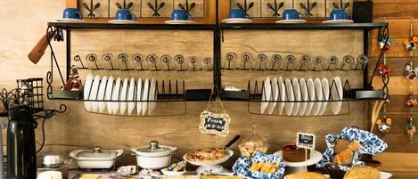 A buffet setup with various dishes and utensils.