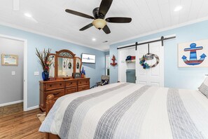 A bedroom with a bed, dresser, ceiling fan, and nautical-themed decor. - Next to Silver Dollar City: Lake Condo with Stunning Table Rock Views & Tickets (Branson)