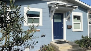 A single-story house with a blue door, white trim, and a small porch. - 30-Night Minimum Downtown HB - 1/2 mile to beach, Pier, Main St, & Pacific City (Huntington Beach)