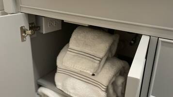 Shower, hair dryer, towels, toilet paper