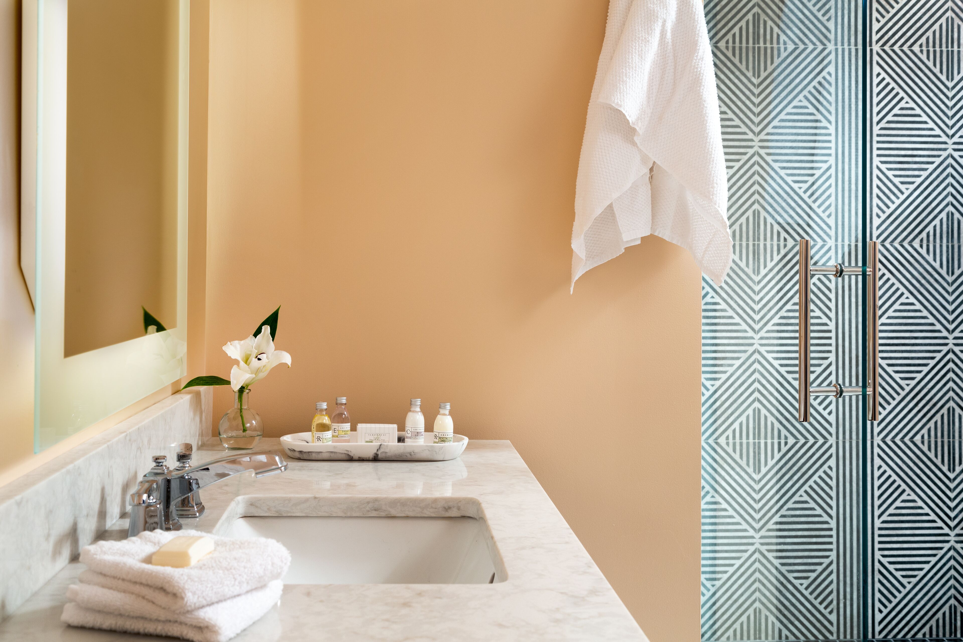 shower, hair dryer, slippers, towels