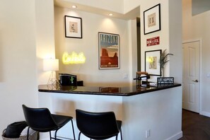A bar area with a neon sign, framed pictures, and a sign that reads "Life Happens But Wine Really Helps". - Desert Golf Oasis at Foothills Retreat w/ FREE Heated Pool!!! (Phoenix)