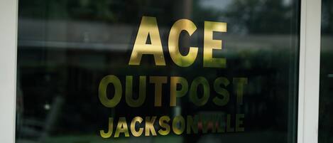 A window with the text 'ACE OUTPOST JACKSONVILLE' in gold lettering.