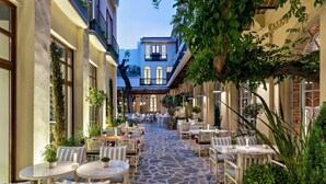 A courtyard with outdoor seating, stone flooring, and potted plants. - Ecole St Pierre Hotel (Istanbul)