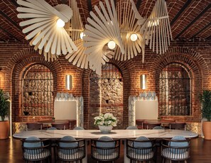 A spacious dining area with a large round table, multiple chairs, and a decorative ceiling fan. - Ecole St Pierre Hotel (Istanbul)