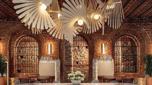 A spacious dining area with a large round table, multiple chairs, and a decorative ceiling fan. - Ecole St Pierre Hotel (Istanbul)