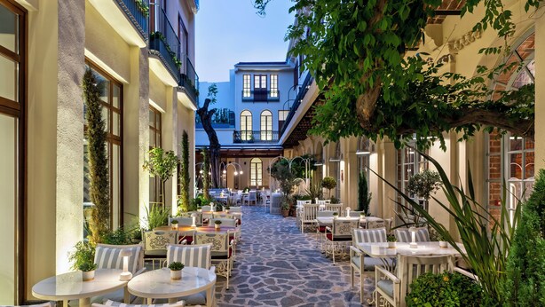 A courtyard with outdoor seating, stone flooring, and potted plants. - Ecole St Pierre Hotel (Istanbul)