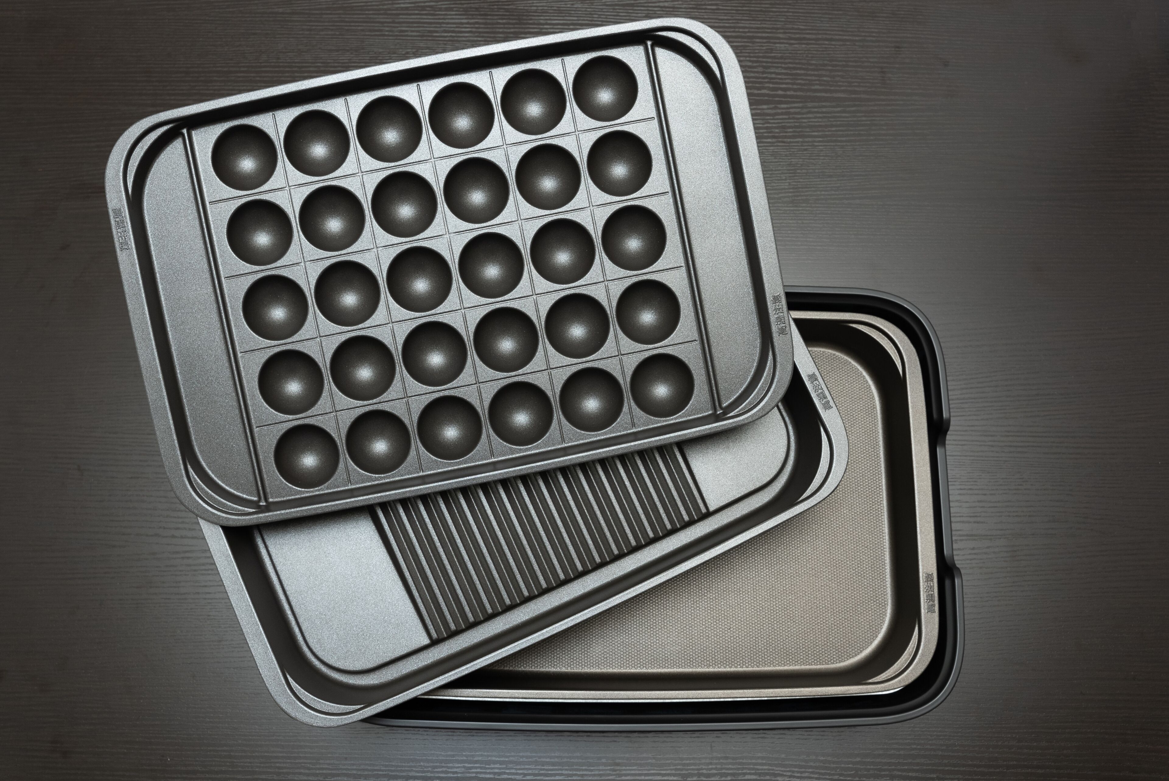 A waffle iron with a grid of round molds.