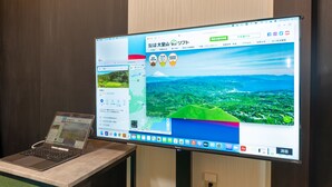 A laptop and a monitor displaying a map and a scenic view. - Izu Workation (Ito)