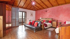 A room with a wooden ceiling, a sofa, a bed, and a wooden cabinet. - Holiday Home with Mountain Views, Balcony and Wi-Fi (Los Valles)