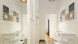 A hallway with white paneling, a double door, and two white desks with drawers. - Schloss am Meer, App. 4 (Heringsdorf)