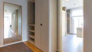A modern interior with a hallway leading to a bathroom.