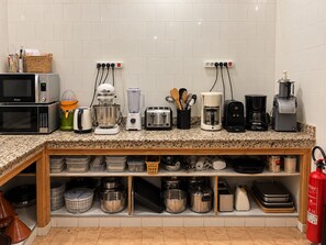 A kitchen with a microwave, toaster, blender, coffee maker, and various kitchen utensils. - Villa Malaa'ika for 20 people (Marrakech)