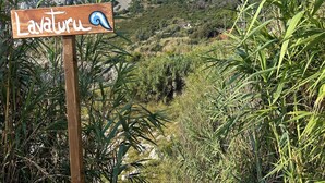 A wooden sign with the name 'Lavaturu' and a blue wave symbol, indicating a coastal location. - Seafront historical villa with fabulous garden and private pool (Marina Serra)