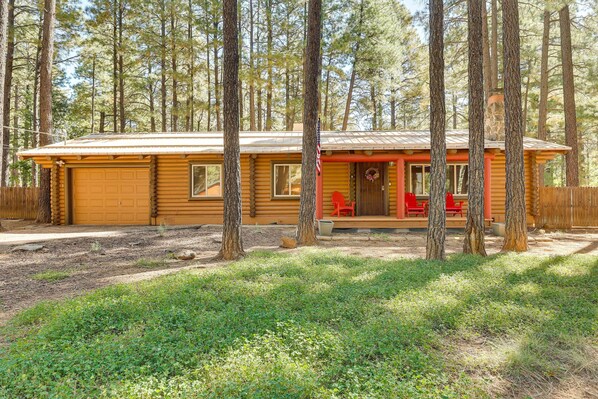 A log cabin with a porch, a garage, and a small deck area. - 11 Mi to Rainbow Lake: Family Home w/ Large Yard (Pinetop)