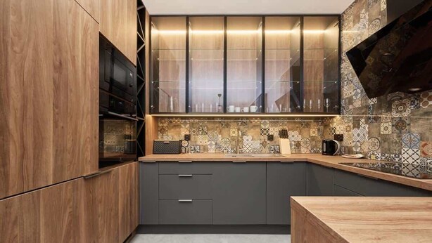A modern kitchen with wooden cabinets, a built-in microwave, and a patterned backsplash. - Stylish Apartment with Balcony | Parking | Close to the Oder River (Wroclaw)