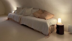A cozy bedroom with a bed, pillows, and a bedside table with a lamp. - Village house with garden and pool (ANSOUIS)