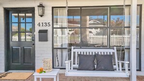 A house with a black front door, a white picket fence, and the number 4135 on the wall. - 4 bedrooms in one of the most popular + charming neighborhoods in Arcadia (Phoenix)
