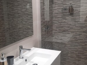 Shower, hair dryer, towels, toilet paper