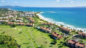 A coastal resort with beachfront villas, a golf course, and a view of the ocean.
