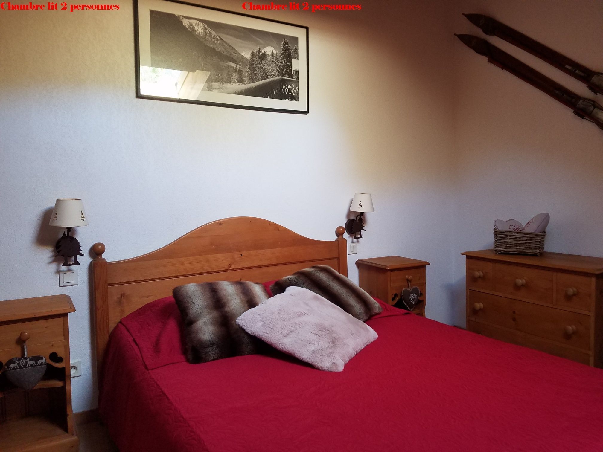 A bedroom with a wooden bed, two bedside tables, a nightstand, a lamp, a dresser, and a framed picture on the wall.