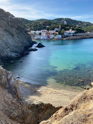 A coastal town with clear turquoise waters, rocky cliffs, and white buildings with red roofs. - Family home with cottage, stunning ocean views, private pool, Sa Tuna (Begur)