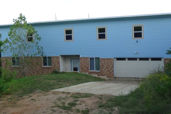 Front of house. The house is not visible from the road.