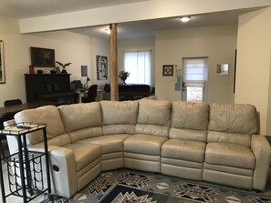 Leather couch with electric raising leg rests in living area. 