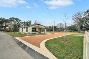 A single-story house with a front yard, a driveway, and a street view.