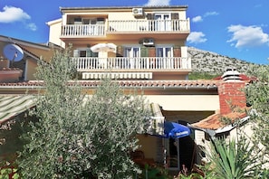 A multi-story building with balconies, a satellite dish, and a chimney. - Villa in Starigrad near Paklenica National Park (Starigrad Paklenica)