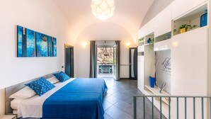 A modern bedroom with a bed, artwork, and a view to an outdoor area. - Maika House - Amalfi Coast - seaview (Atrani)