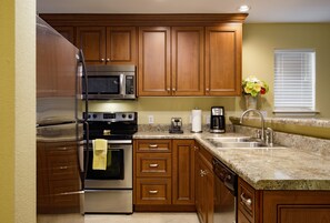 Enjoy cooking in this well-lit kitchen with a double sink, microwave, and toaster.