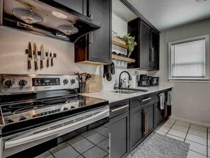 Fridge, microwave, oven, stovetop - The Noir-a Modern 3 BR Bungalow in the heart of OKC! (Okahoma City)