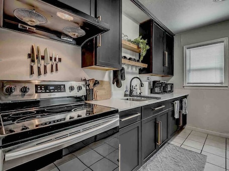 Fridge, microwave, oven, stovetop. The Noir-a Modern 3 BR Bungalow in the heart of OKC!