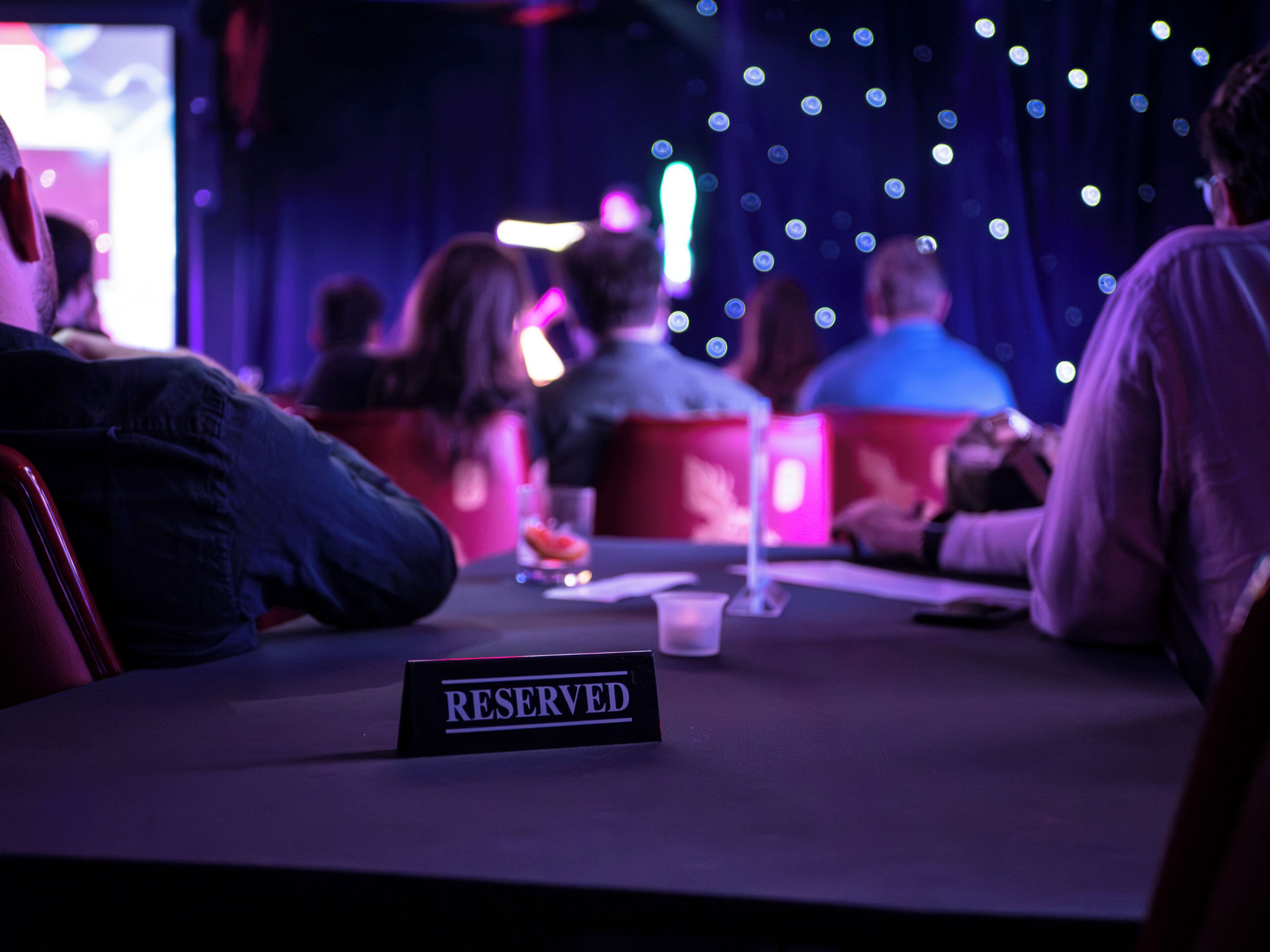 A reserved seating area with a sign indicating it is reserved.