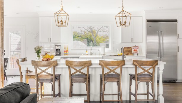 A modern kitchen with a central island, wooden chairs, pendant lights, and a stainless steel refrigerator. - Wine Country Escape, Heated Pool + Hot Tub Near Wineries (Santa Rosa)