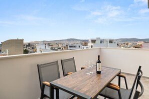 Enjoy a romantic dinner for two on this rooftop terrace overlooking the city and distant mountains.