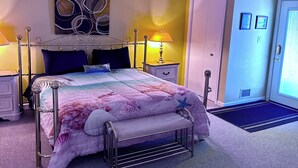 A neatly arranged bedroom with a bed, bedside tables, a bench, and a door.