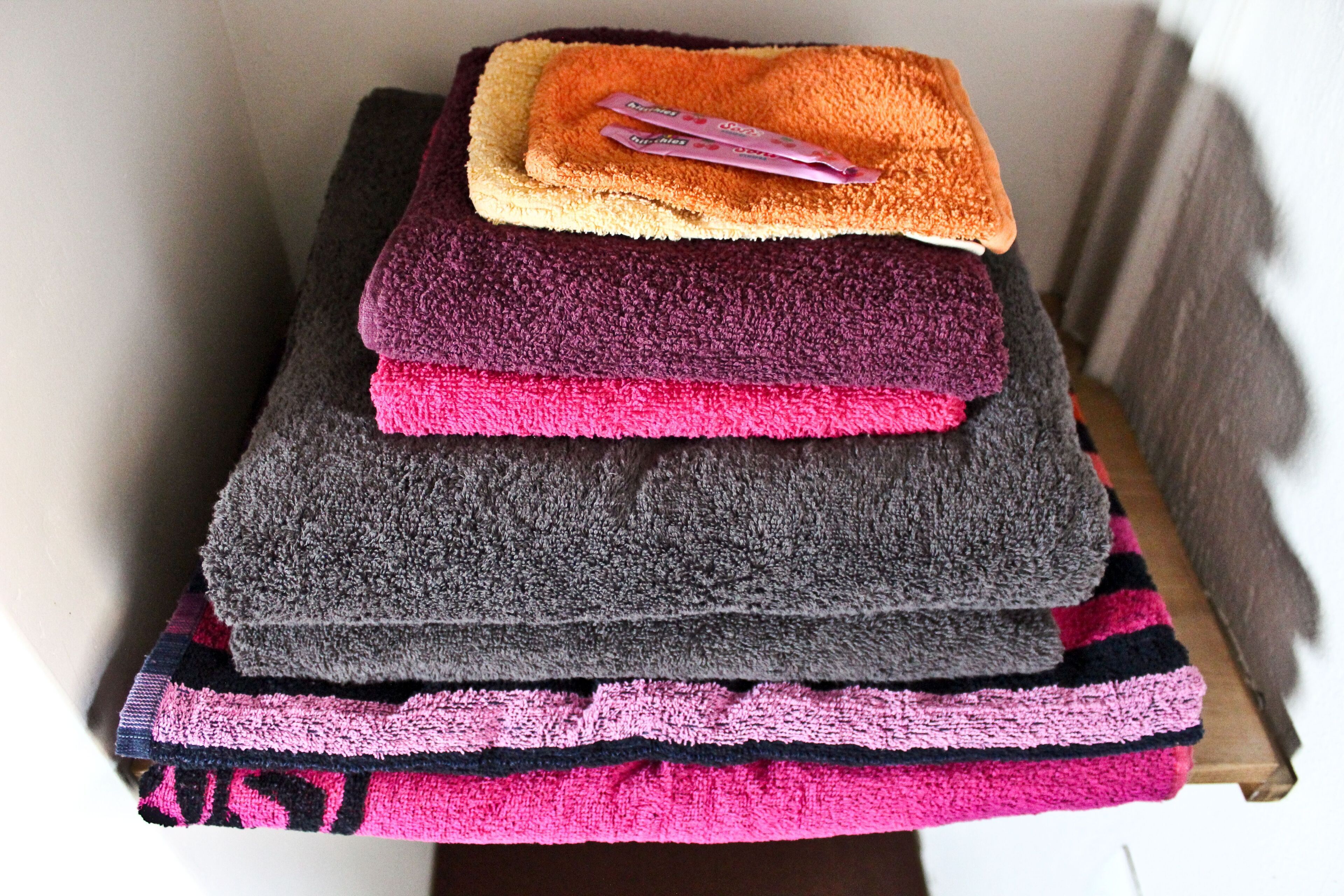 A stack of towels in various colors.