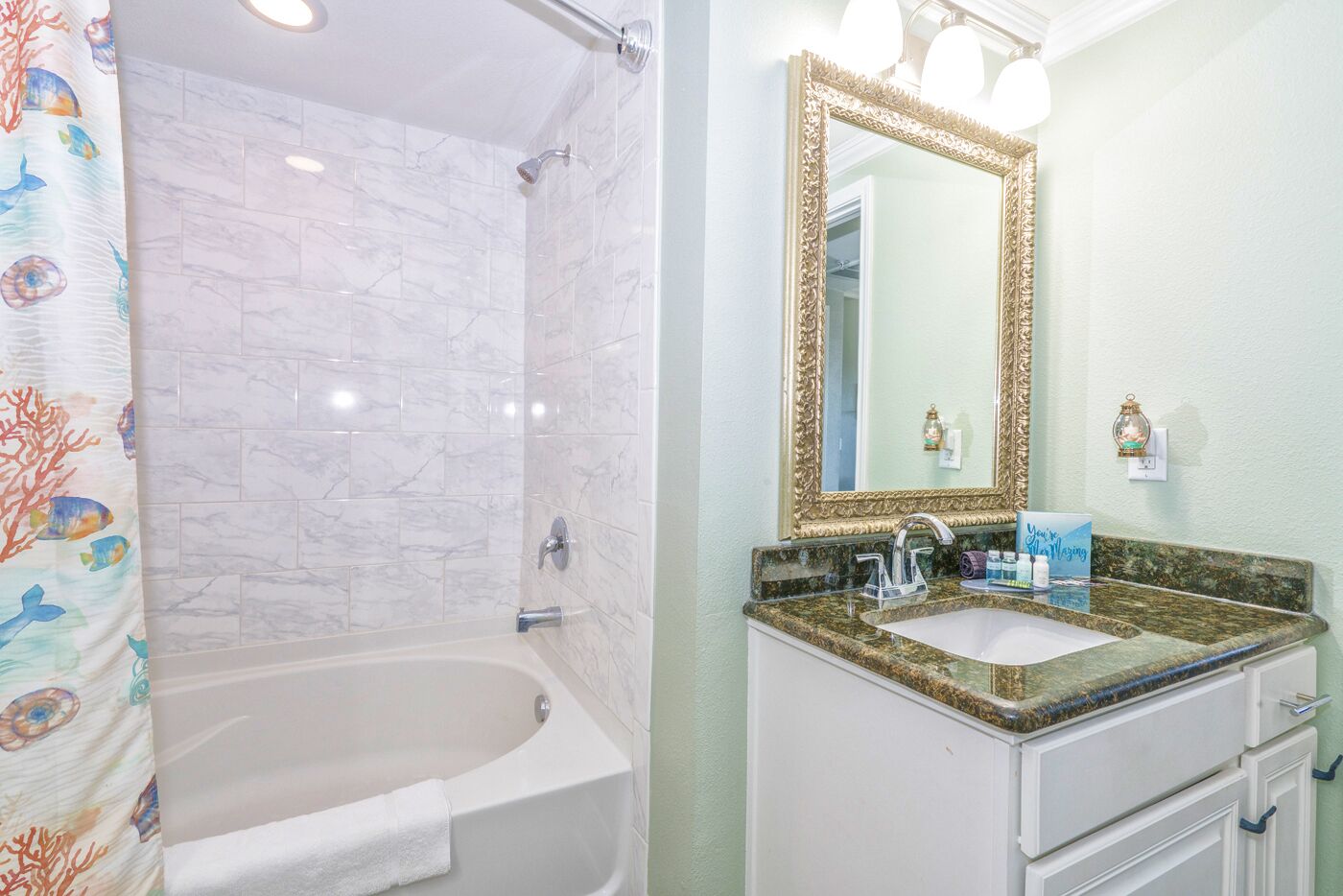 A bathroom with a bathtub, a sink, and a mirror.