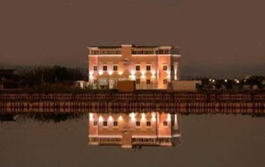 A building with a symmetrical facade, multiple windows, and a central entrance. - Hotel Belvedere (Margherita di Savoia)